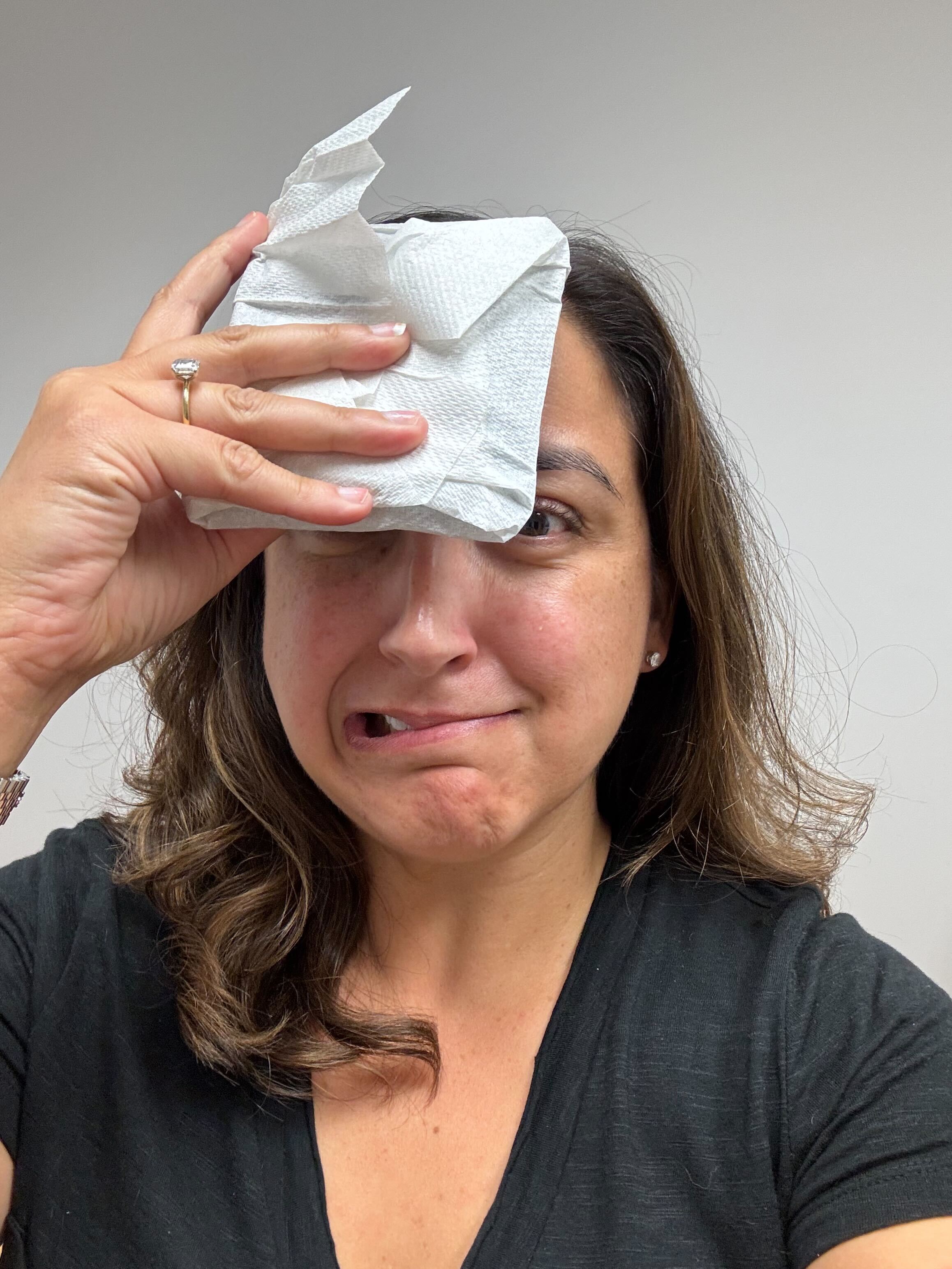 A clinician pressing a compress to a client's forehead
